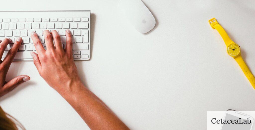 person typing on Apple Cordless Keyboard
